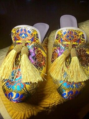 Silk  Embroidered mules with silk tessels.